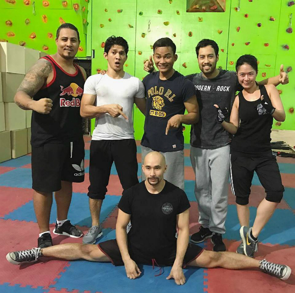 Tim Man does the splits with the Triple Threat cast: (from left) Eric "Newik" Cullet, Iko Uwais, Tony Jaa, Kazu Patrick Tang and Jeeja Yanin.